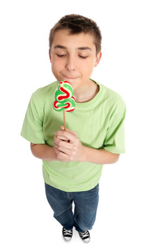 男孩拿著甜美味的圣誕糖果