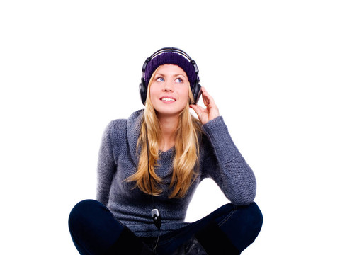 微笑的金發(fā)女人帶著耳機聽著音樂