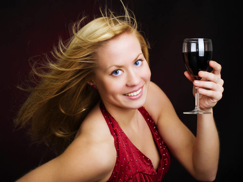 微笑的美女手捧美酒慶祝新年