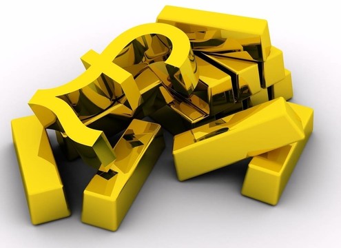 白色背景上的金條和金色磅符號。