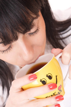 漂亮的女商人拿著咖啡杯。