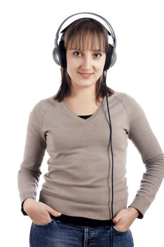 年輕迷人的微笑女孩在耳朵里聽音樂