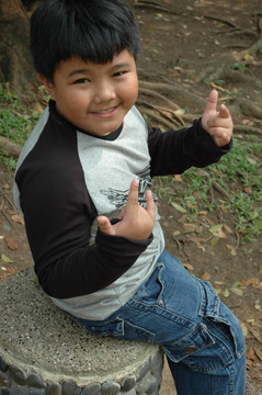 小男孩坐在公園里
