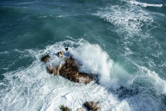 憤怒的風(fēng)暴海浪到達(dá)一塊大石頭和飛濺的水