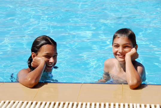 游泳池里的微笑的孩子们