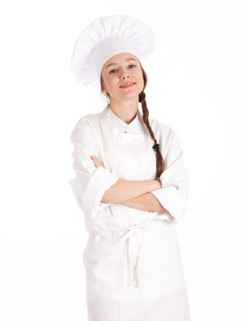 微笑的女廚師穿著白色制服，戴著交叉胳膊的帽子