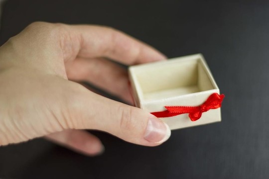 手持黑色背景禮品盒