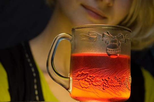 女孩和一個(gè)有熱飲料的杯子