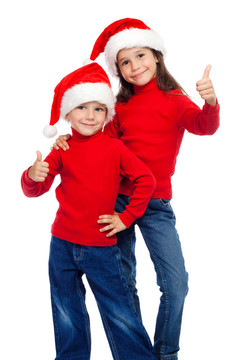 兩個面帶微笑的孩子豎起大拇指和Santa的帽子