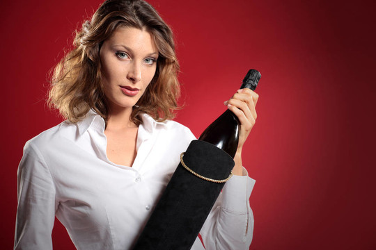 年輕迷人的女人與一瓶汽酒；禮品盒
