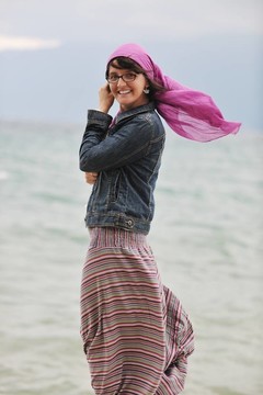 美麗的年輕女子在海灘與圍巾