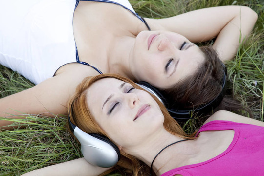 兩個十幾歲的女孩聽MP3播放器