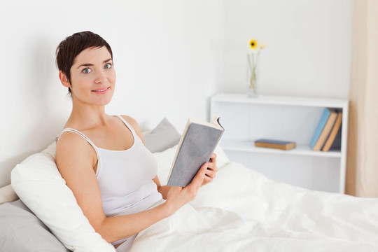 年輕女子拿著一本書