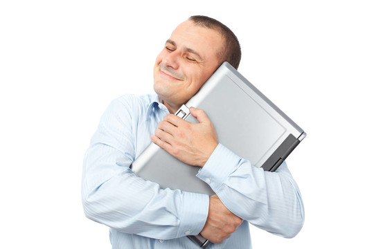快樂的商人拿著他的筆記本電腦