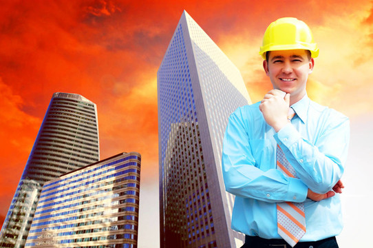 站在建筑物背景上的年輕建筑師戴著防護頭盔