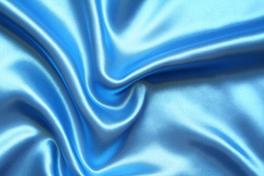 以流暢的優(yōu)雅的藍(lán)色絲綢為背景