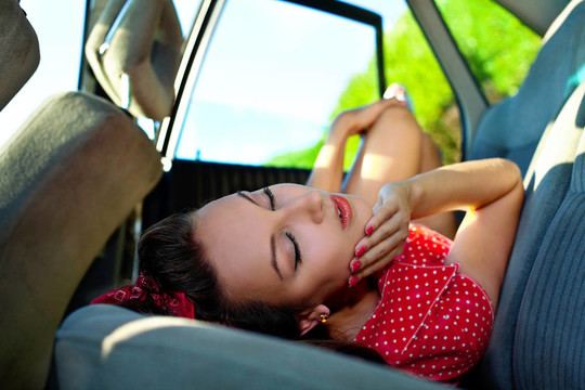 年輕性感的女人躺在車(chē)精致的風(fēng)格