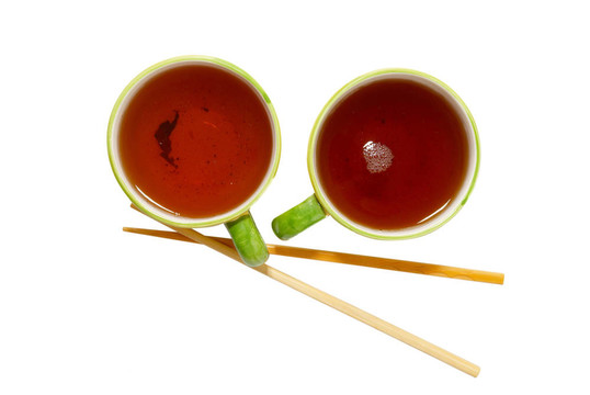 兩個(gè)茶杯喝茶、筷子白色隔離。
