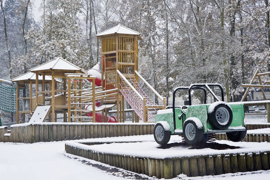 在冰雪覆蓋的公園里，空蕩蕩的孩子們的操場上到處都是初雪