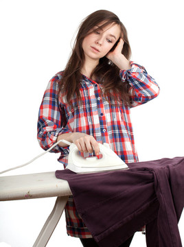 疲倦；傷心的年輕婦女熨燙衣服；家務(wù)