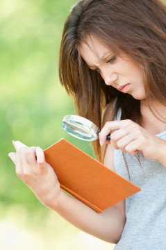 年輕的女人放大鏡以書(shū)