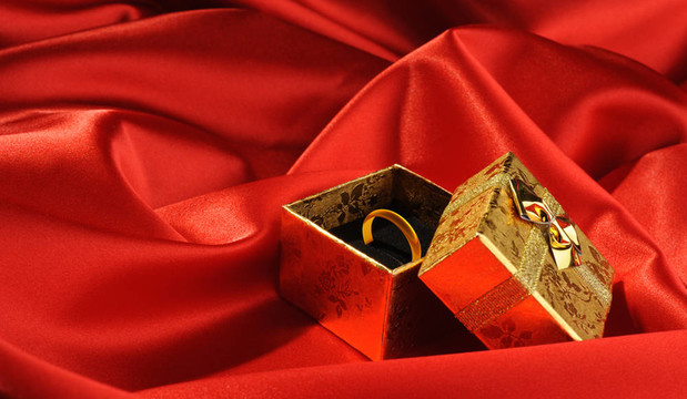 帶紅色絲綢結(jié)婚戒指的金盒子