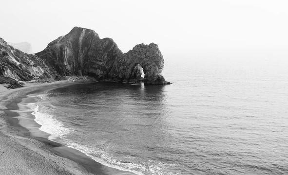 和平的黑色和白色的石拱門；Lulworth Cove景觀