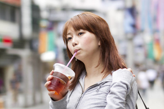 年輕漂亮的女人喝果汁