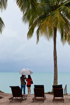 情侣在沙滩上凝视着大海