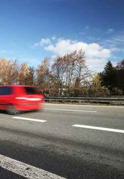 在高速公路上快速行駛的汽車