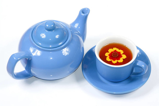 藍(lán)色水壺和一杯有花的茶