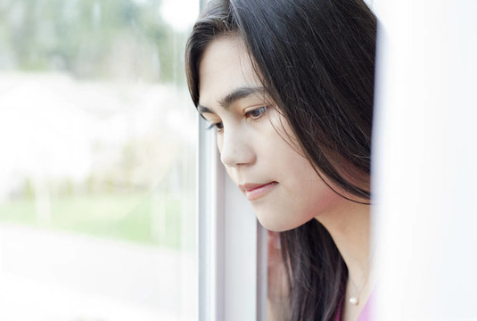 側(cè)面的青少年女孩或年輕女子看窗外