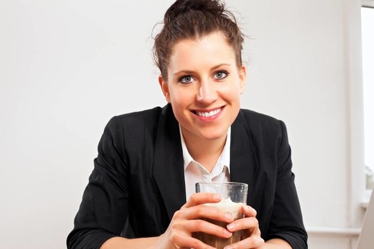 微笑的女人拿著一杯巧克力飲料