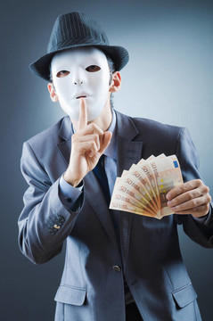 商人用金錢和面具