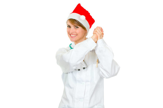 微笑女醫(yī)生在Santa帽子顯示合作伙伴姿態(tài)孤立在白色