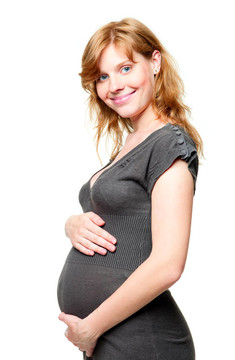 年輕的孕婦把手放在肚子上