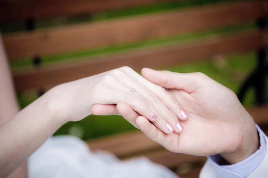 新郎把結(jié)婚戒指戴在新娘的手指上