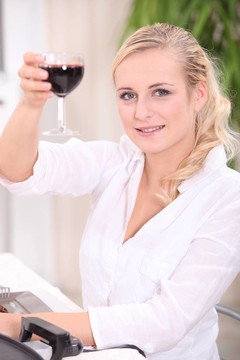 金發(fā)女人喝紅葡萄酒