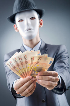 商人用金錢和面具