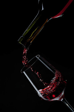 紅酒倒入黑色的酒玻璃