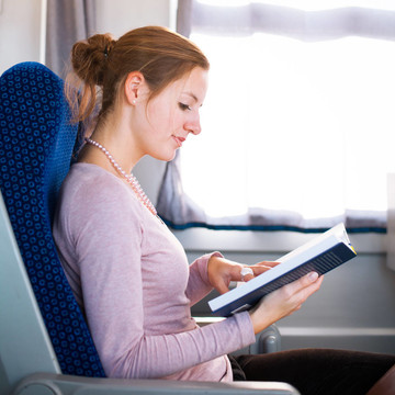 年輕女子在火車上看書