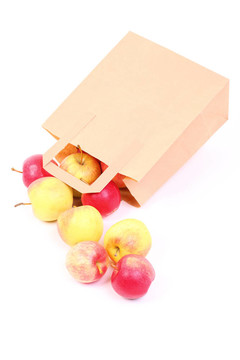 購(gòu)物棕色禮品袋和蘋(píng)果隔離