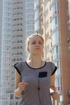 年輕美女在城市街頭跑步