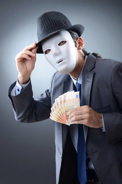 商人用金錢和面具