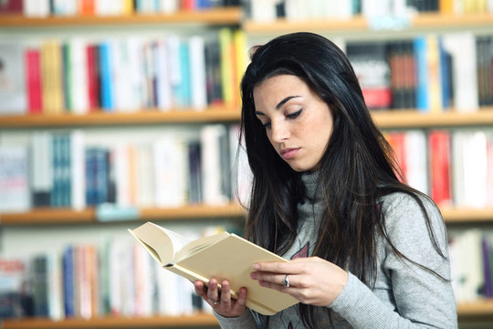 女大學(xué)生在圖書館看書