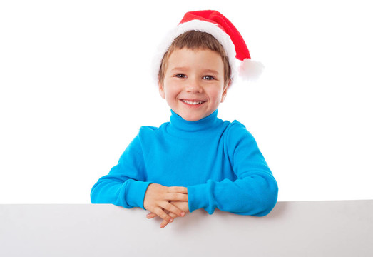 微笑的男孩在Santa帽子與空旗幟