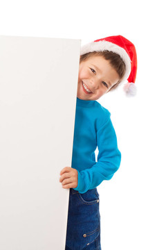 微笑的男孩在Santa帽子與空旗幟