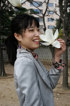漂亮的韓國女人拿著一朵花