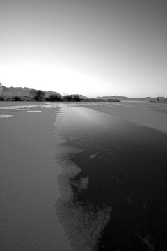 在黑色和白色的Frozen Lake上空日出
