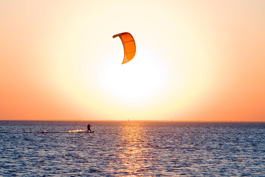 在一個(gè)日落灣kitesurfer剪影